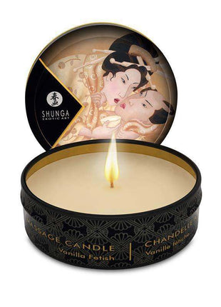 Shunga Mini Vela de Masaje Vanille massage candle in a black round tin with gold details and a lit wick