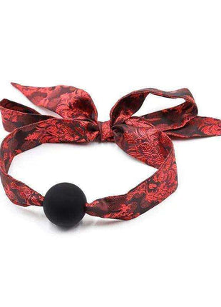 Silicone Ball Gag Red/Black with a smooth black ball and red patterned fabric strap tied in a bow