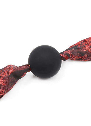 Silicone Ball Gag Red/Black with a smooth black ball and red-and-black patterned fabric strap