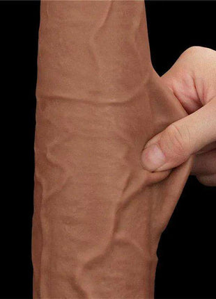 Sliding Skin Dual Layer realistic dildo in tan TPE, shown with its flexible outer skin pinched to reveal the dual-layer design