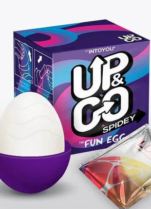 Spidey Masturbator Egg with a white textured top and purple cup-shaped base, shown beside its colorful box and lubricant sachet