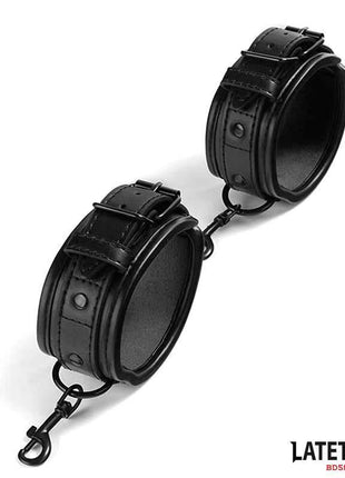 Sponge Lined Handcuffs in black PU with padded interiors, adjustable buckle straps and detachable connecting chain