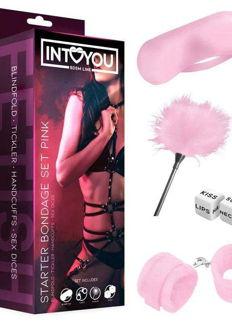 Starters Bondage Set with pink restraints, feather tickler, blindfold and playful dice beside black packaging