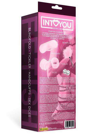 Starters Bondage Set in pink packaging, showing soft pink restraints, a fluffy feather tickler, blindfold and dice
