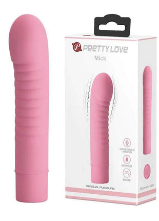 Stimulator Mick Silicone Pink, a smooth pink silicone vibrator with a rounded tip and ribbed shaft, beside its retail box