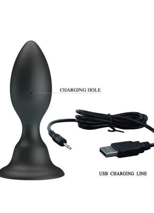 Vibrating Butt Plug in matte black silicone with a tapered rounded tip, flared base, charging port, and USB cable