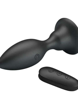 Vibrating Butt Plug in matte black with a smooth contoured body, flared base, and separate three-button remote