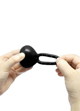 Vibrating Cockring with Remote Control Black, a black flexible ring with a rounded vibration unit and elongated loop