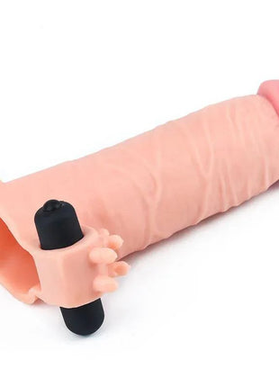 Vibrating Penis Sleeve in pale pink soft material, with a ribbed shaft, flared open base, and black vibrating bullet