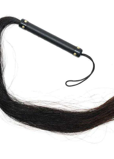 Whip with Horse Hair featuring a long black hair tail, black leather handle, brass studs, and wrist loop