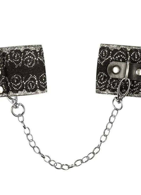 Wrist Cuffs with Lace featuring black fabric with a white ornate pattern, silver snaps, and a connecting chain